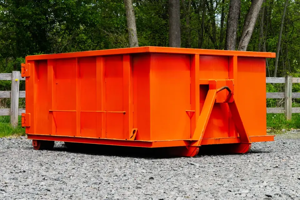 Small roll-off dumpster on gravel